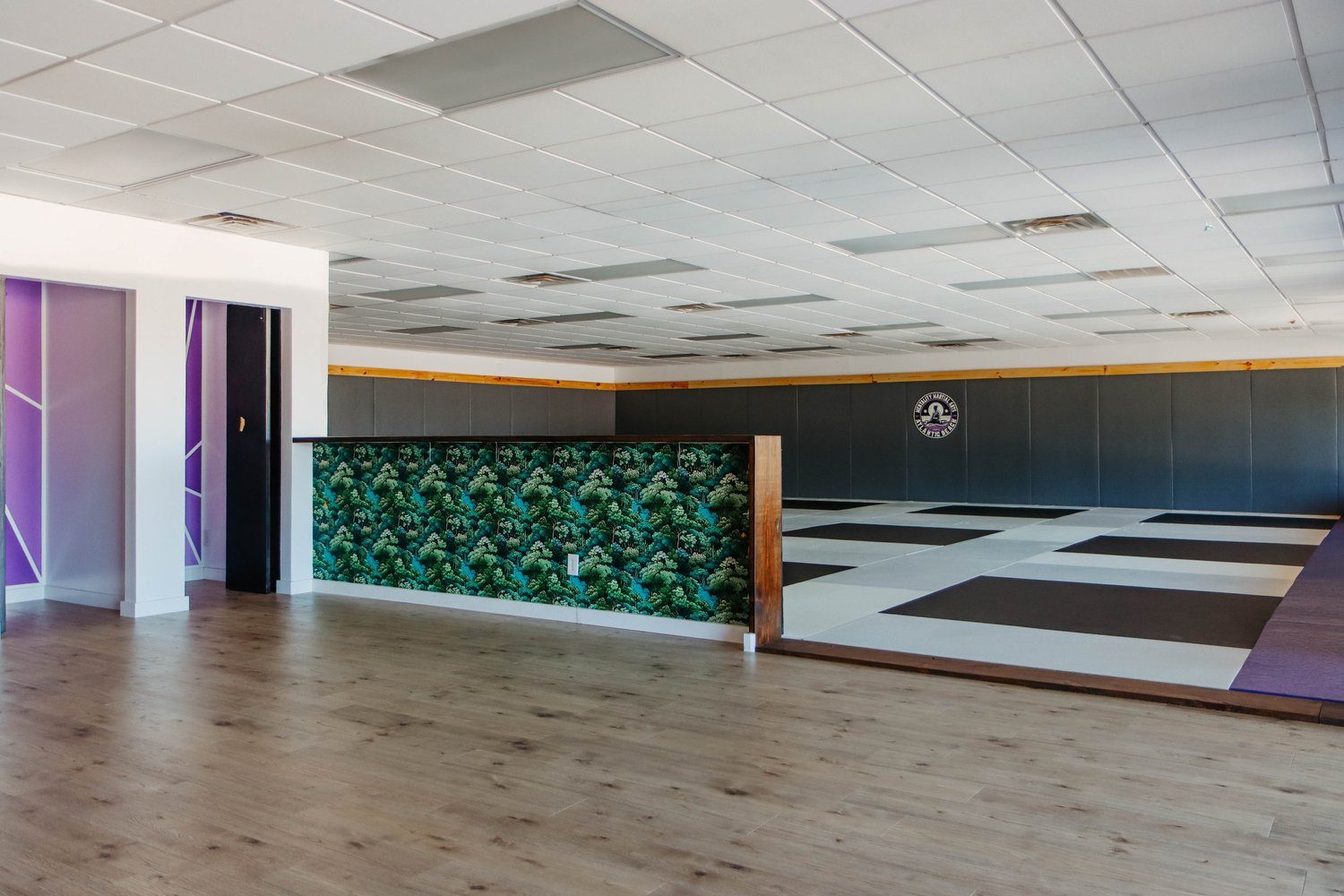 Front lobby, reception desk, and black-and-white mat room inside Mentality Martial Arts at 1447 Mayport Road.